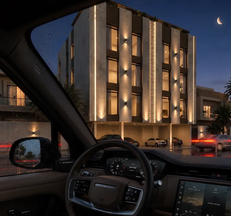 The residential building at night, seen from the street